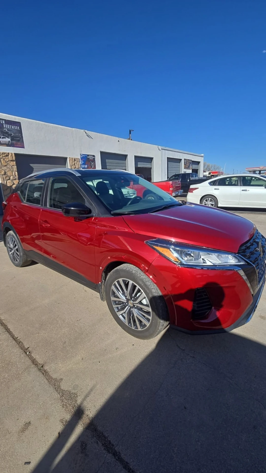 Red Nissan Kicks fully repaired and repainted after front-end collision work